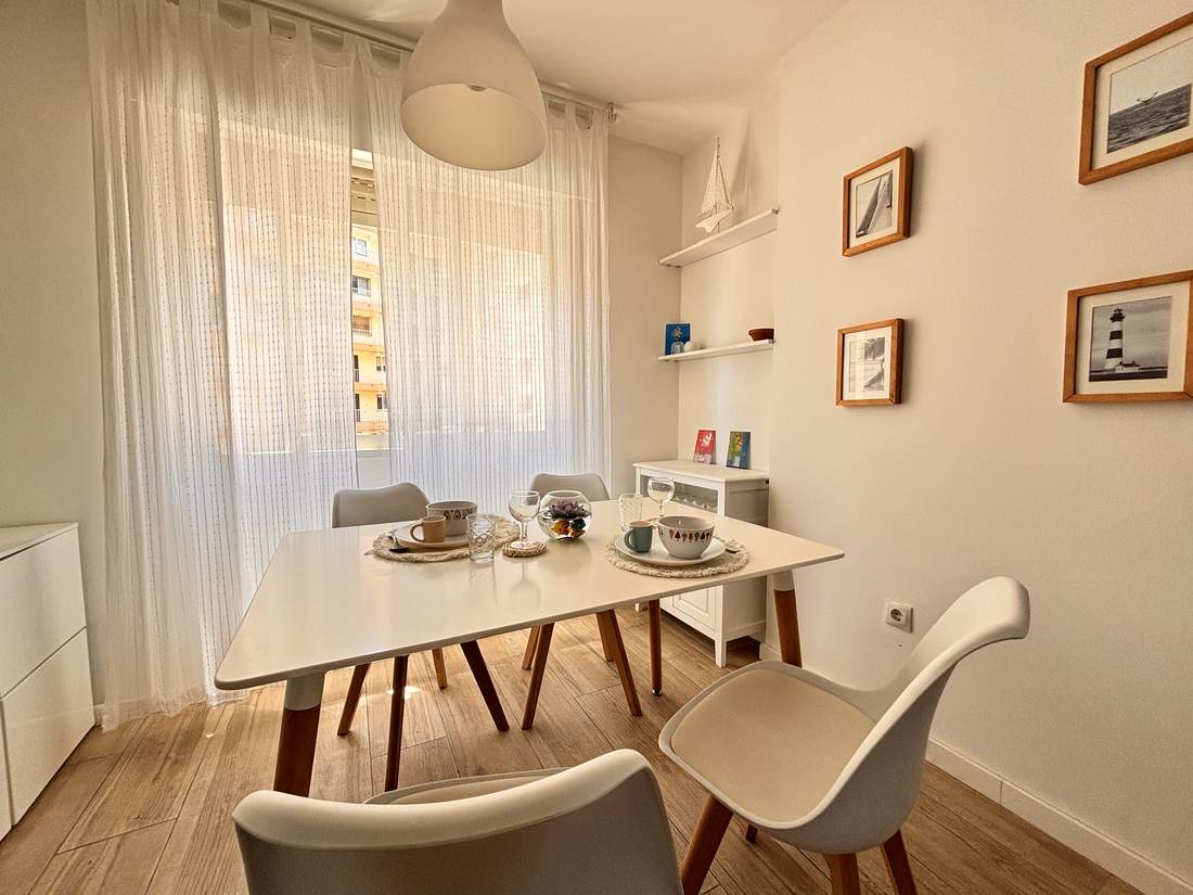 Comedor con mesa blanca y sillas nórdicas