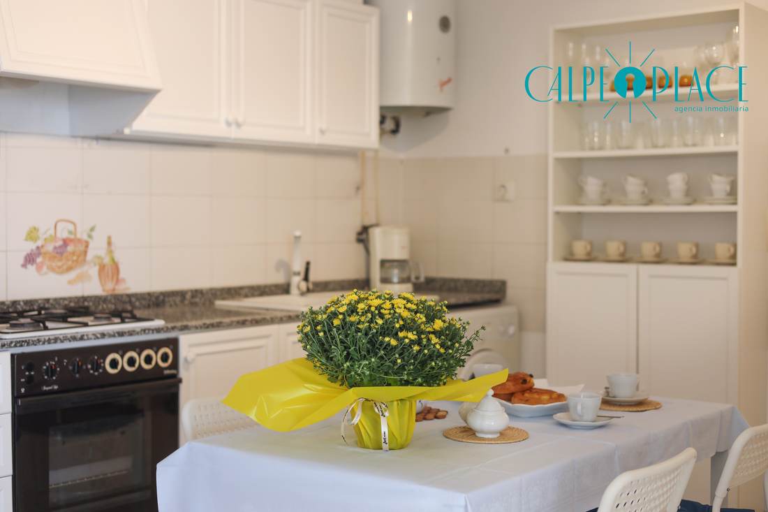 Cocina con la mesa de comedor y sillas azules
